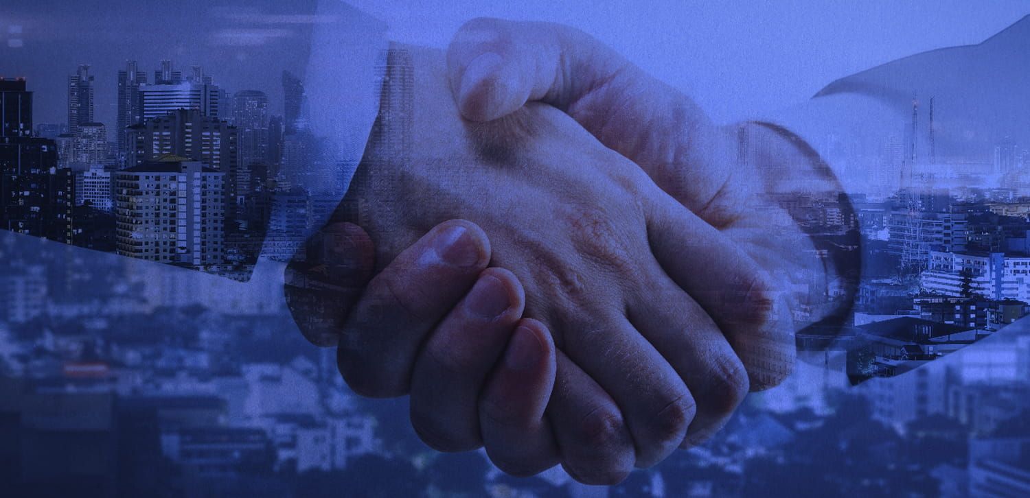 Handshake with a city in the background